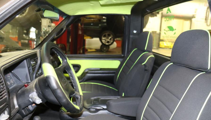 Interior of the truck cab, decorated in black and green.
