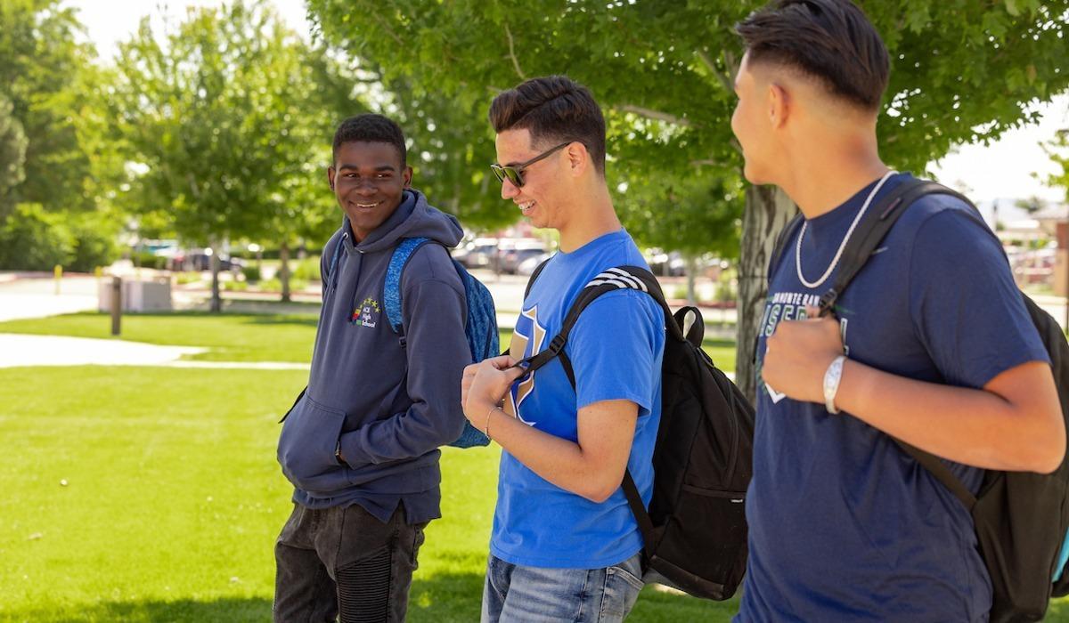 Three TMCC students enjoy each other's company while walking through the plaza on a beautiful summer day.