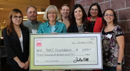 TMCC Foundation members with an oversized check from CREW.