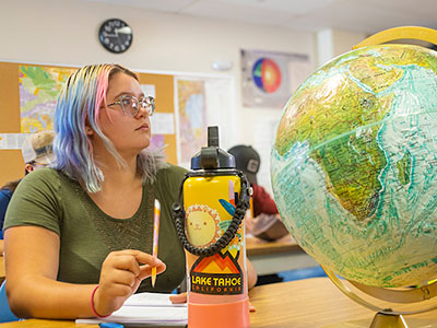 Student with globe.