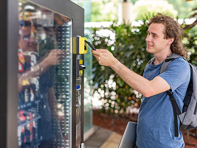 Person using vending machine.