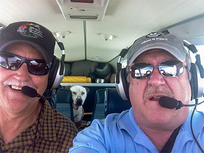 Two Pilots and Dog Image in Airplane