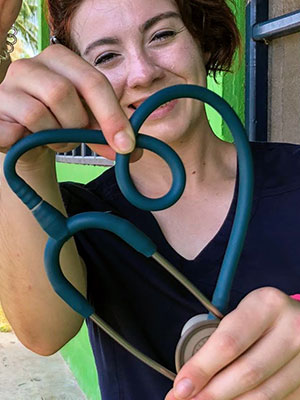 Goodman holds up her stethoscope in the shape of a heart.
