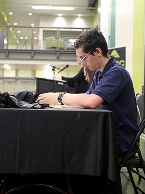 Student sitting at an event table.