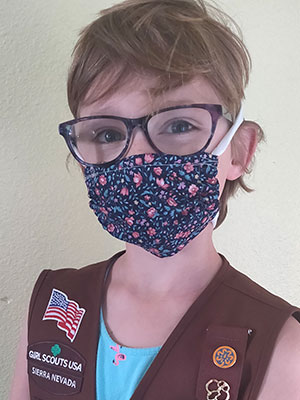 Girl scout wearing a homemade cloth mask.