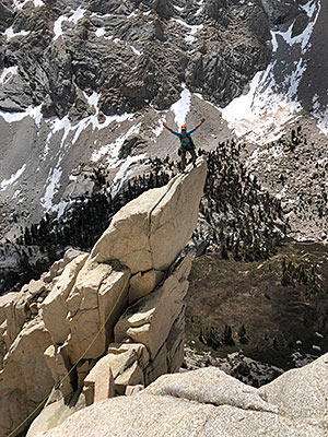 Roger Putnam on top of a mountain peak.
