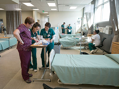 Nursing Instructor Checking Patient