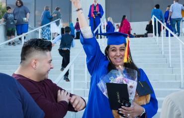 Graduate with arm held up