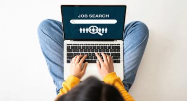 Student on a laptop conducting a job search online.