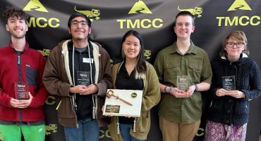 Student Government Association representatives hold awards representing their service to TMCC and its students.