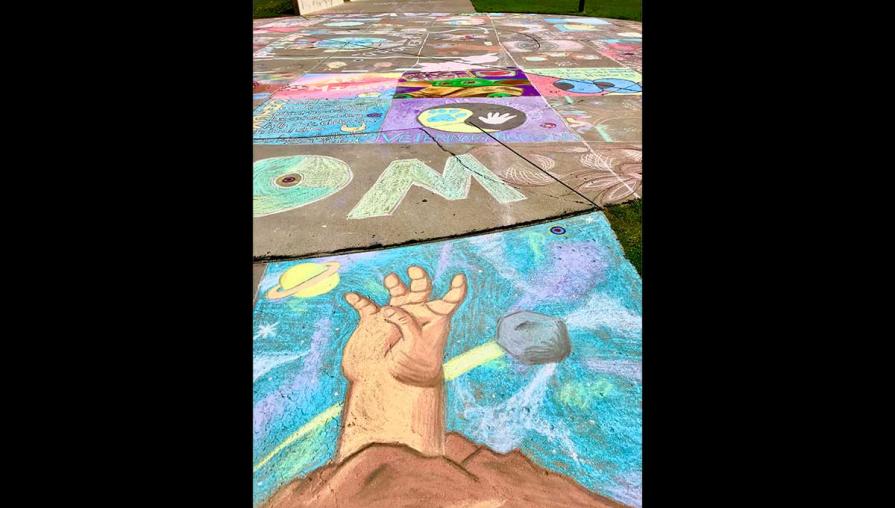Chalk drawing of an outstretched hand.