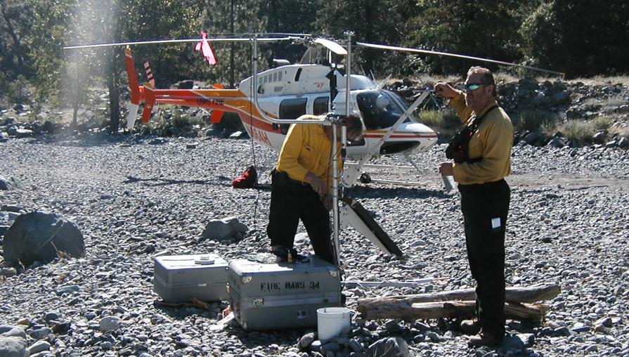 Firefighters set up a mobile weather station on a sandbar