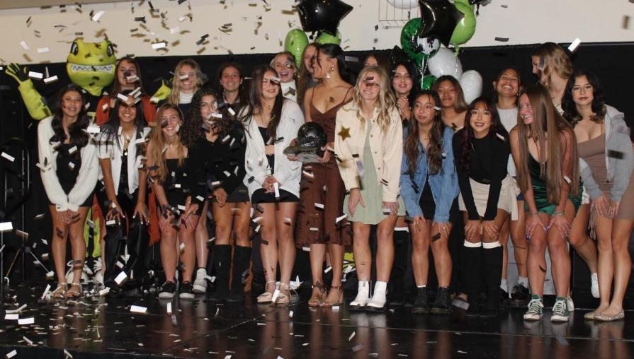 The Women's Soccer team comes together for a photograph during a confetti pop.