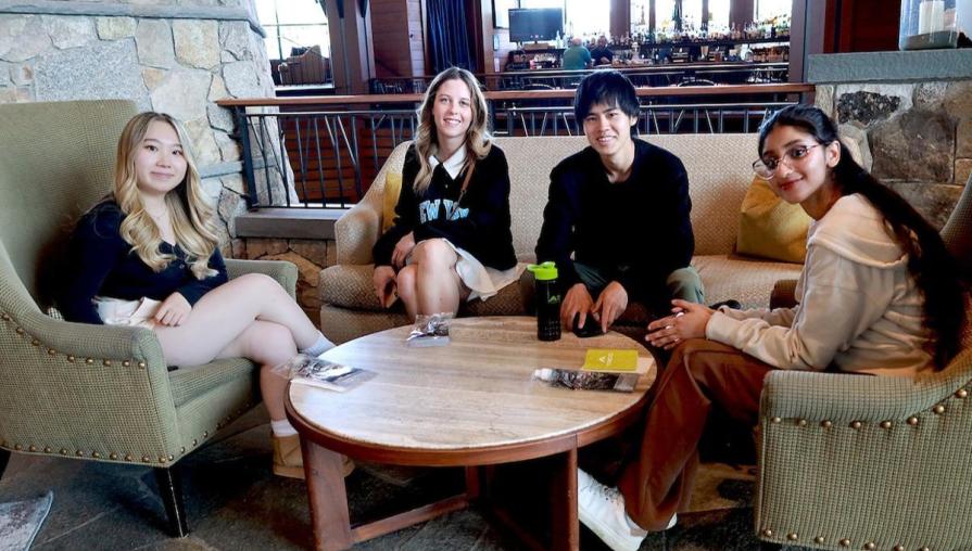 Hospitality students relax in the lobby after completing a hotel tour and its indulging comforts.