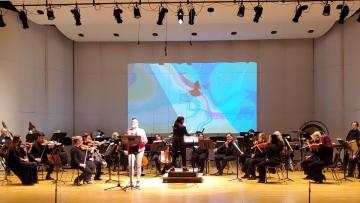 Caroline Shaw conducts the Reno Chamber Orchestra alongside the visual storytelling of "The Mountain That Loved a Bird" at Nightingale Concert Hall.
