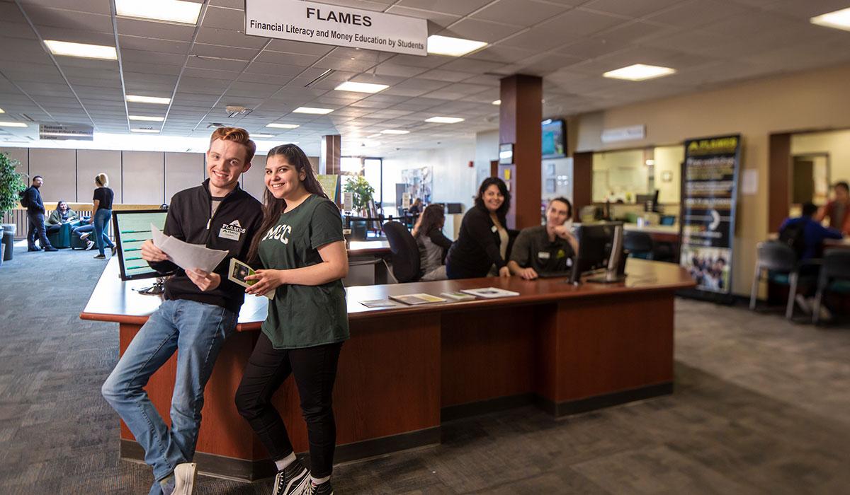 Students standing at the FLAMES desk.