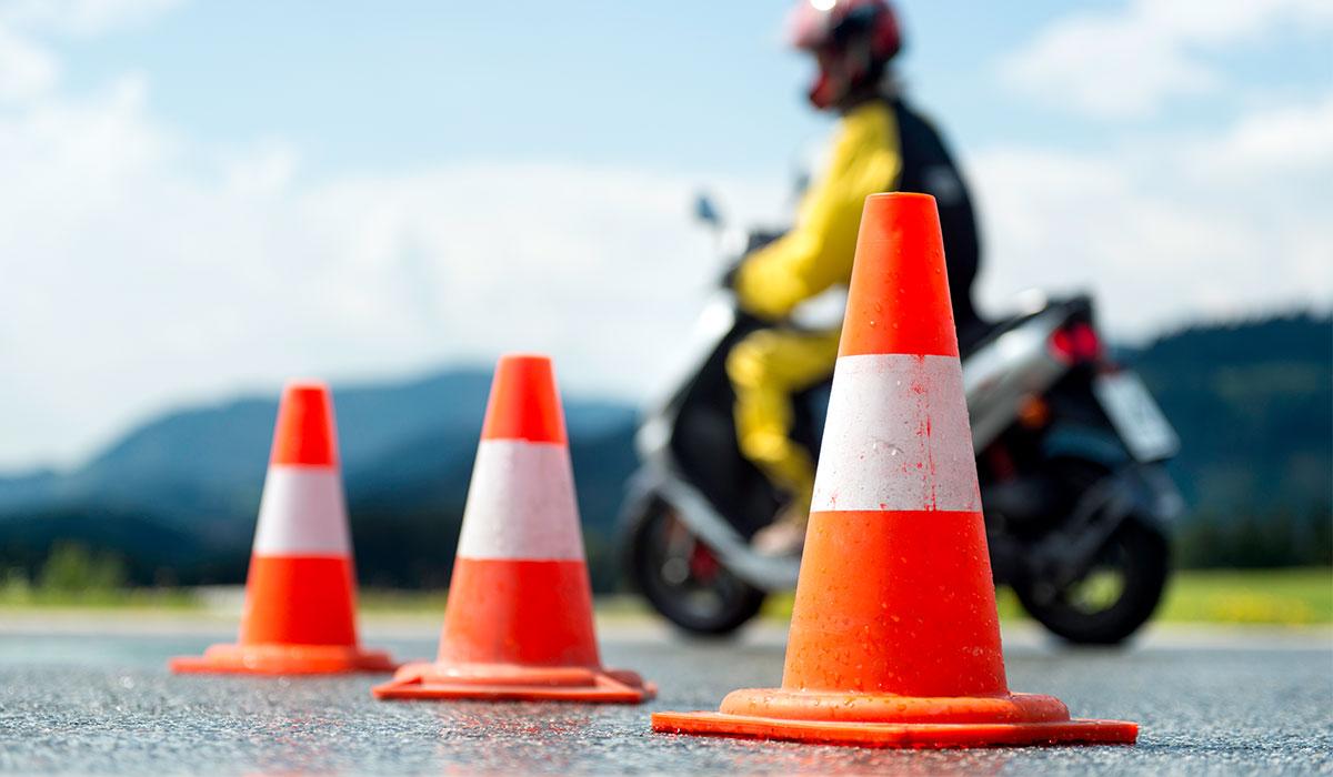A motorcycle near orange traffic cones.