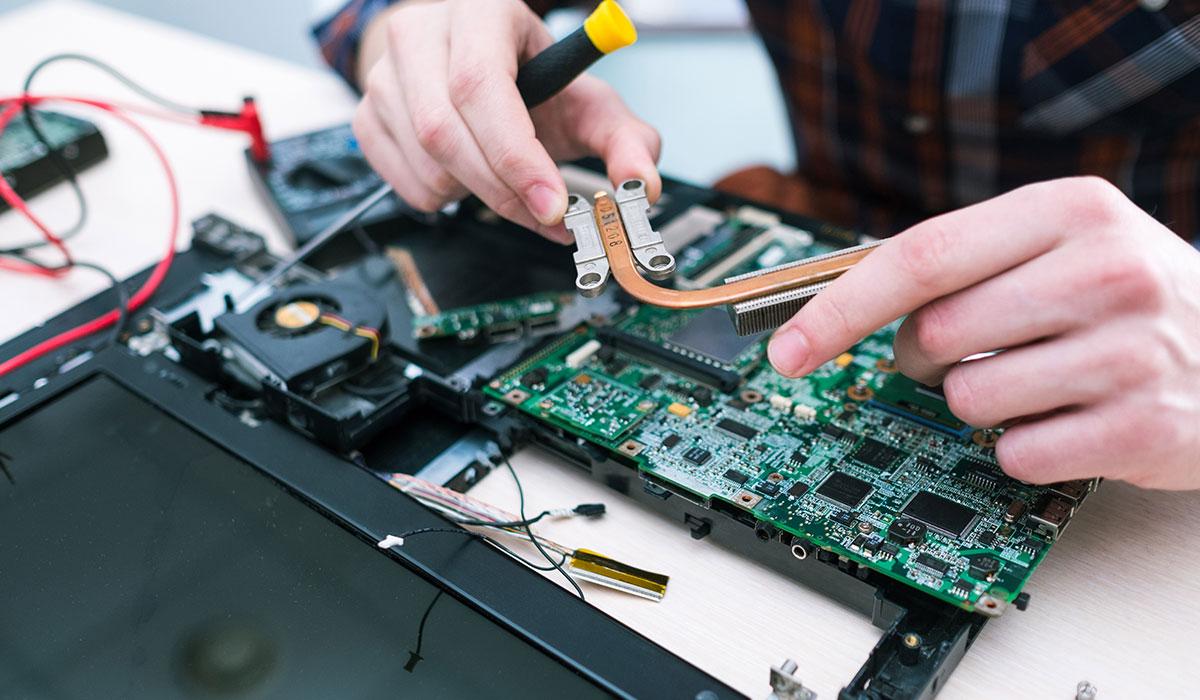 Photo of hands working on electronic equipment.