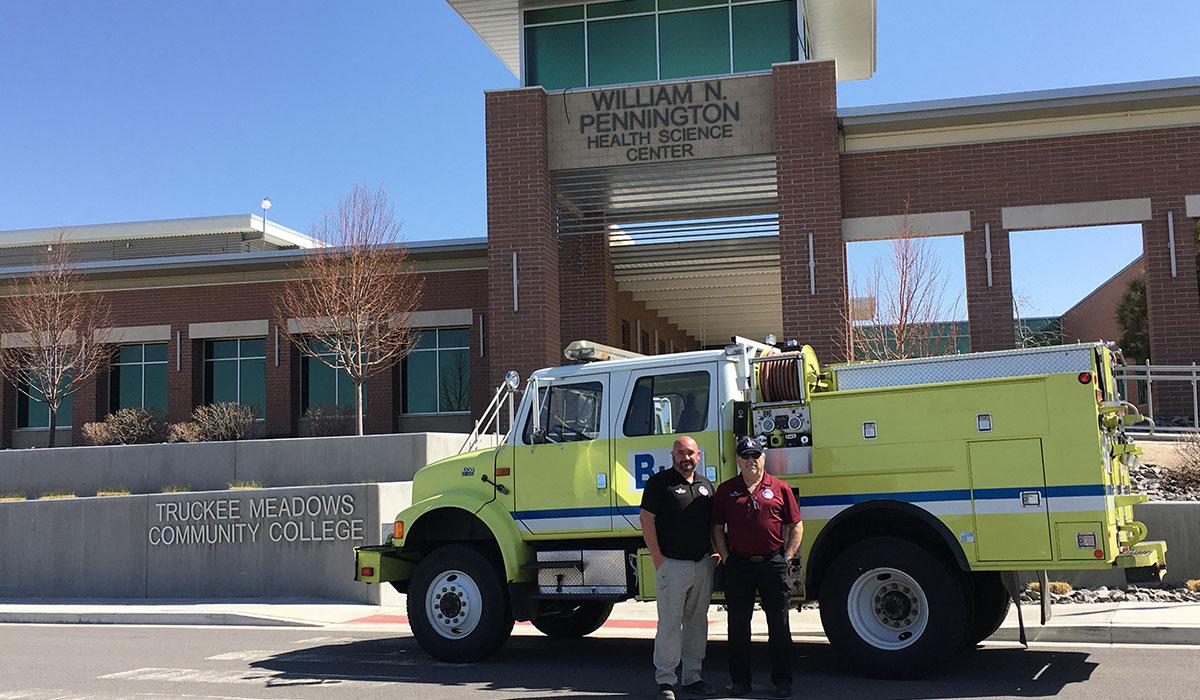 public safety director mike schulz and program coordinator sandy munns with a fire engine donated by the TMFPD