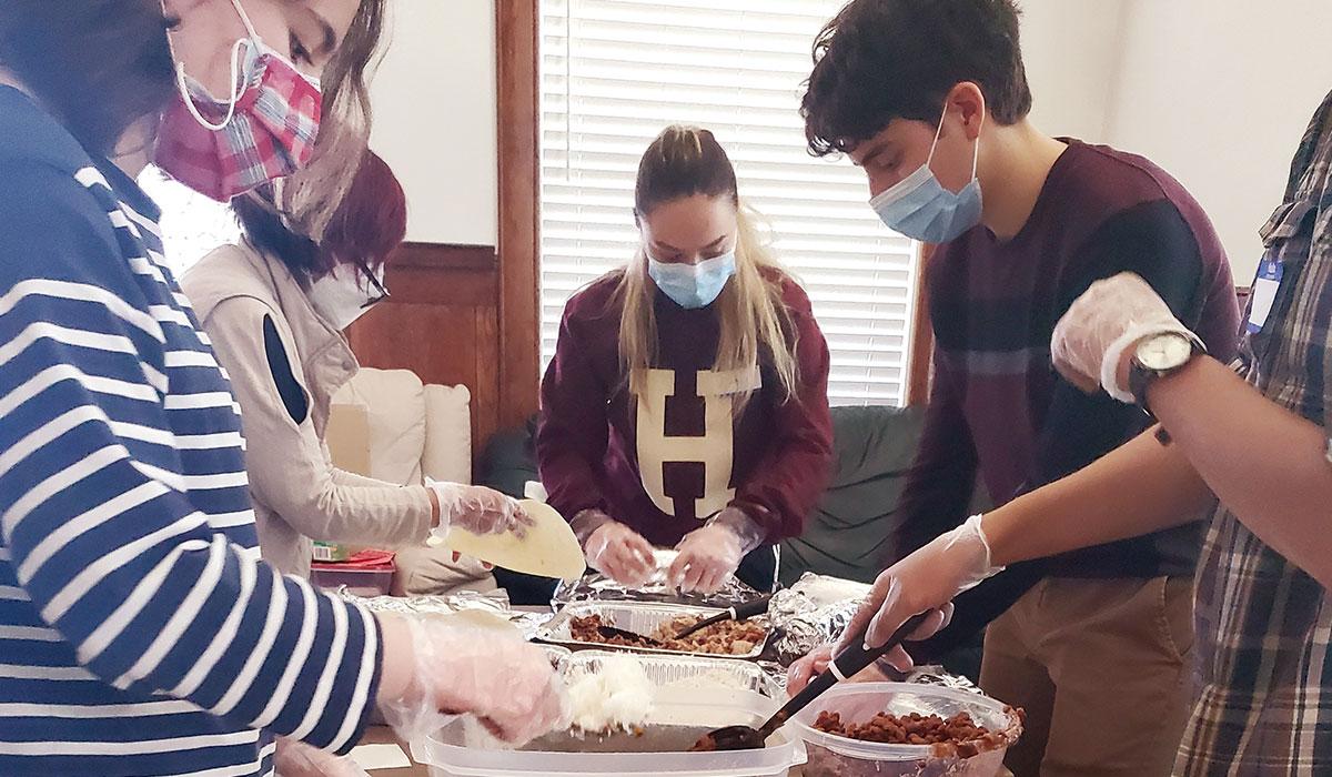 students in the business and entrepreneurship club make burritos for the reno burrito project