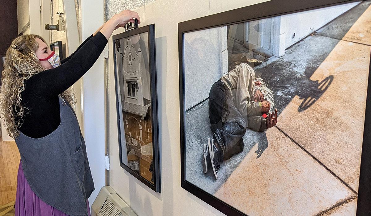 TMCC photography student hangs her work in an exhibit entitled "Street." 
