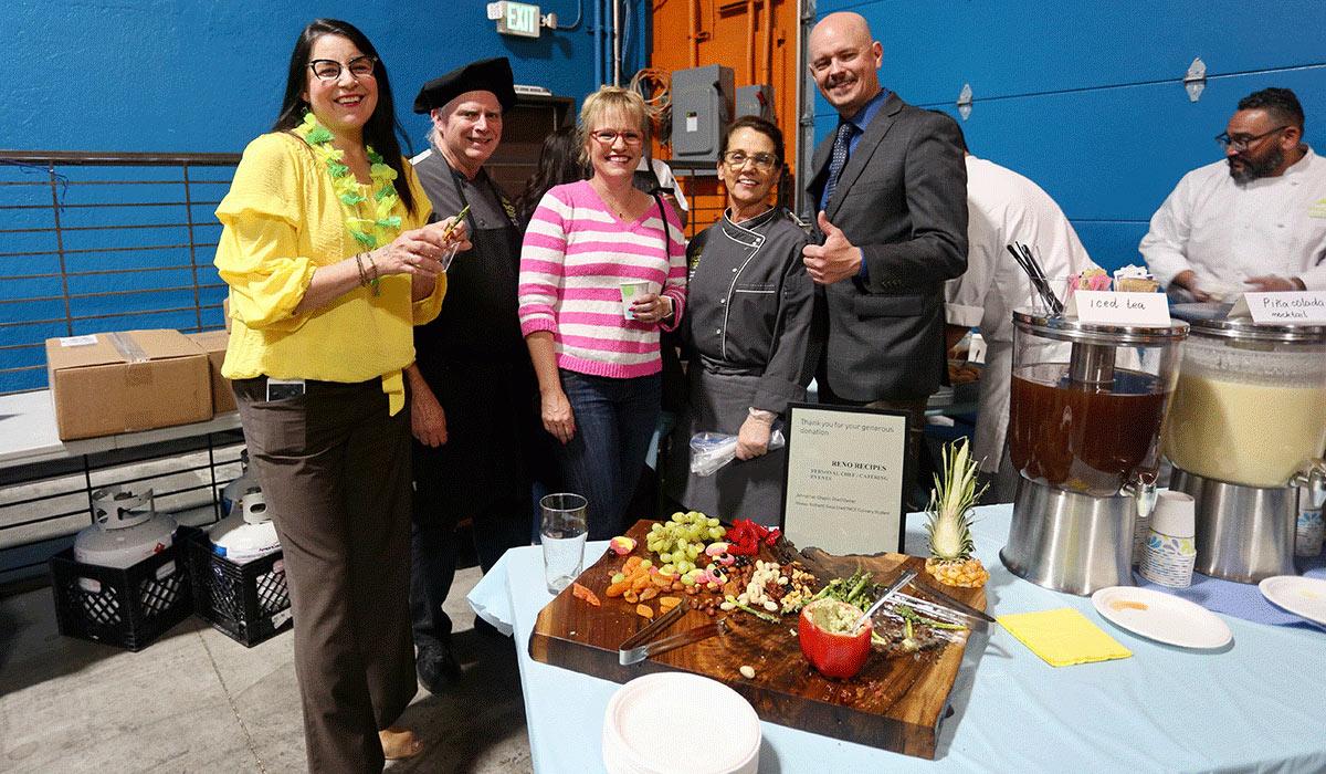 A group of TMCC Culinary Arts faculty and leaders with a charcuterie board.