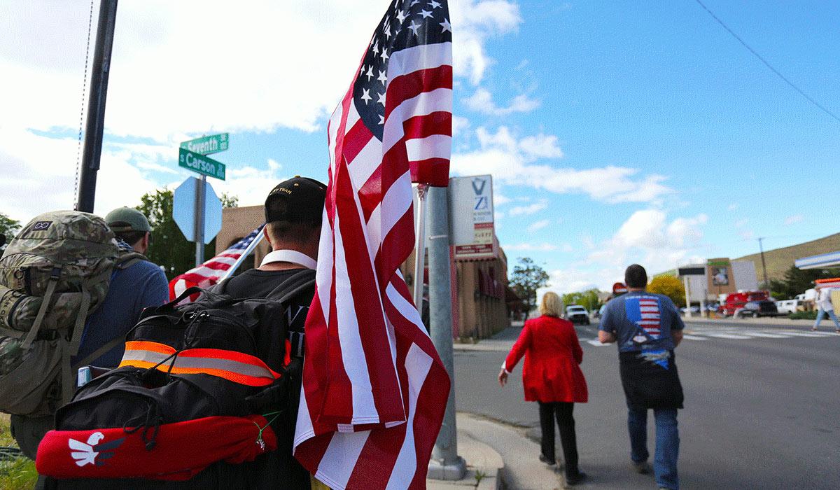 Student veteran holding the American flag during the 2019 Ruck to Remember.
