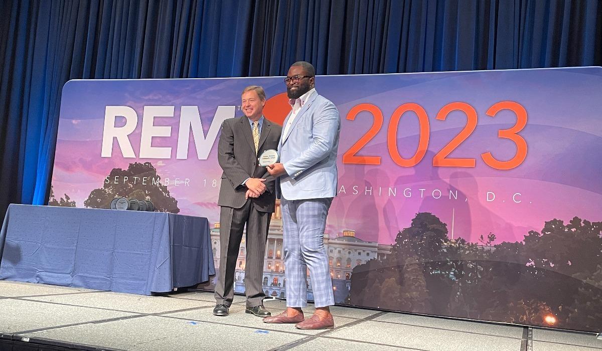 Ayodele Akinola accepts the 2023 Green Power Leadership Award for TMCC at the Renewable Energy Markets Conference.