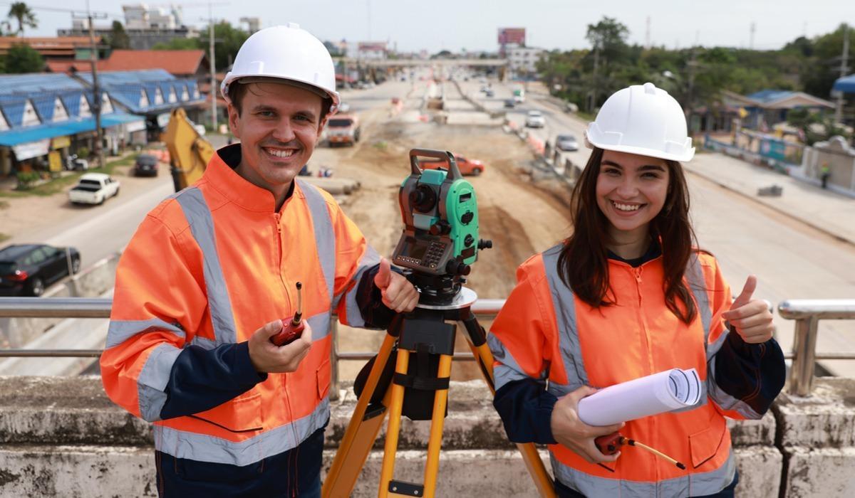 College students working with a geospatial data management tool at a construction site.