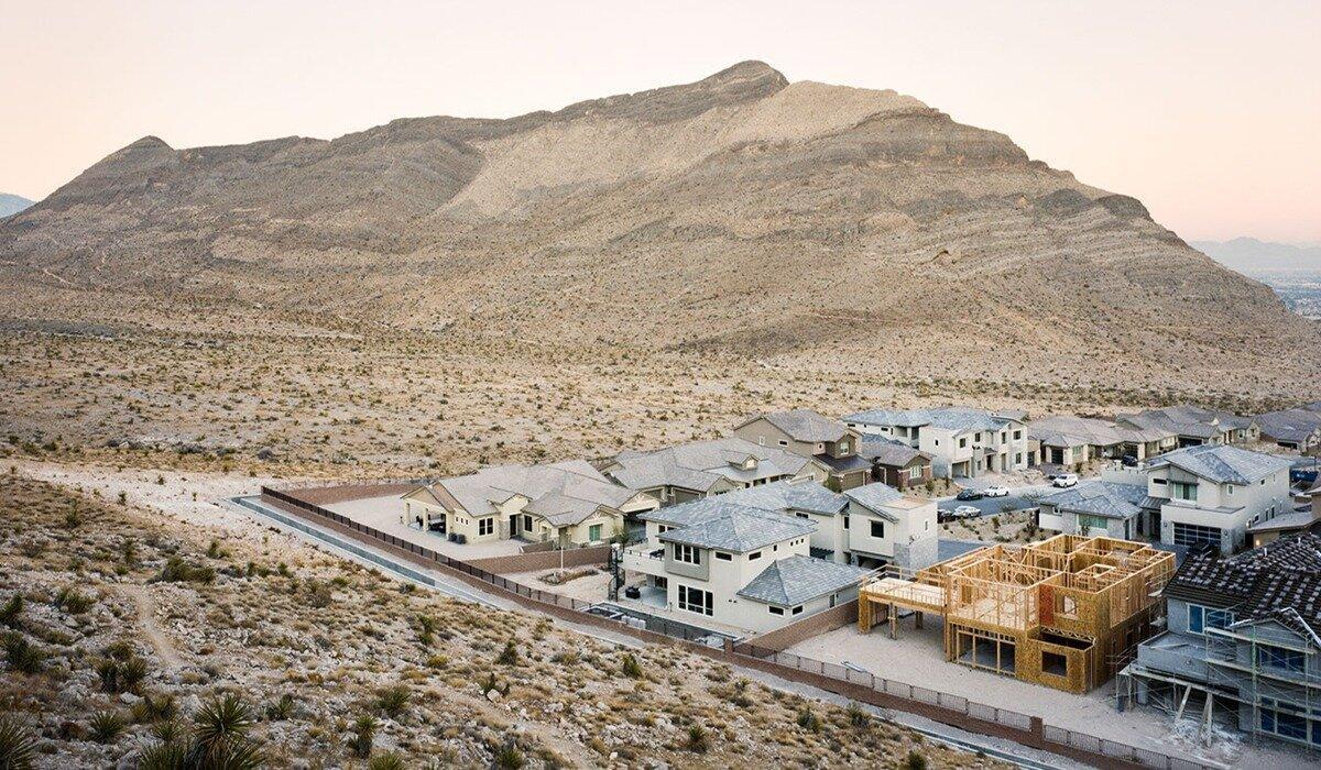 "Desert City" by Bobby Lee. An urban neighborhood in Nevada sits beside a beautiful mountainous range at sunset.
