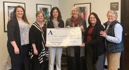 TMCC Foundation accepting donation from AWCMS.