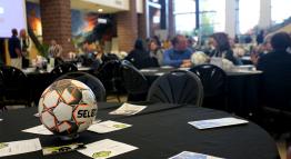Soccer ball at the center of a banquet table.