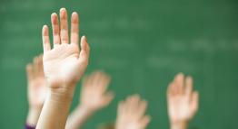 raised hands with blurred green background