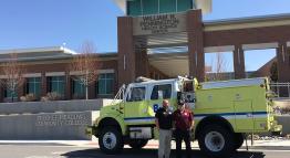 public safety director mike schulz and program coordinator sandy munns with a fire engine donated by the TMFPD