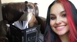 TMCC Student Kat Costa and her puppy pose with the math textbook she wrote.