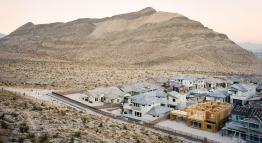 "Desert City" by Bobby Lee. An urban neighborhood in Nevada sits beside a beautiful mountainous range at sunset.