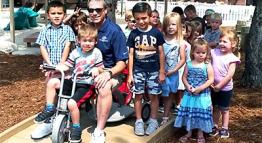 Mark Fraga Visiting with Children