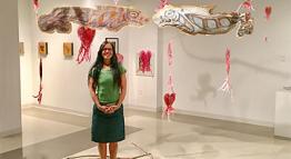 Micaela Rubalcava Standing with her Exhibition Artwork