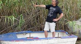 Bill Gallegos Standing in Boat and Pointing