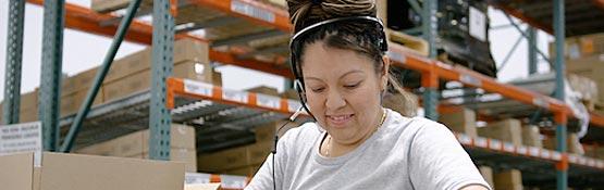 Worker wearing a headset in a warehouse