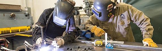 Two welders working together