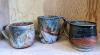 Three ceramic mugs.