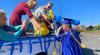 family celebrates with graduate in cap and gown
